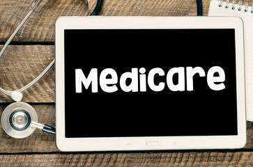 MEDICARE word on the screen of the tablet.