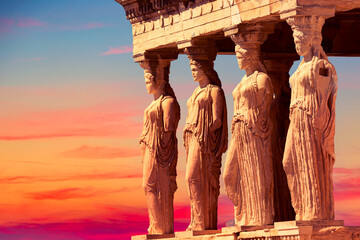 Detail of Caryatid Porch on the Acropolis uring colorful sunset in Athens, Greece. Ancient Erechtheion or Erechtheum temple. World famous landmark at the Acropolis Hill.