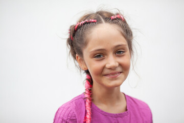 Emotional portrait of a 9-year-old girl with red pigtails