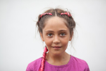 Emotional portrait of a 9-year-old girl with red pigtails