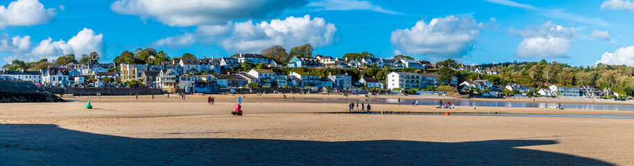 Fototapeta na wymiar A panorama view across the front beach at Saundersfoot, South Wales on a sunny day