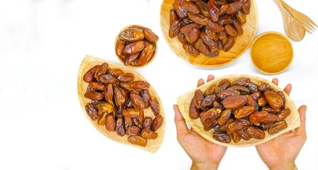 Fresh and healty premium honey tunisia dates (kurma tunisia) in a wooden bowl isolated on white background
