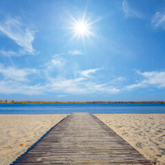 Fototapeta premium wooden road on sandy beachat hot sunny day