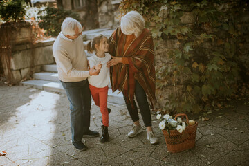 Grandparents enjoying good time with their little granddaughter