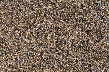 Beach sand of small, tiny pebbles and seashells
