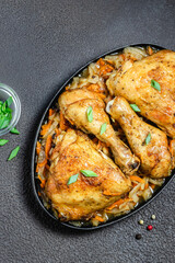 Roasted chicken with cabbage on dark background. Space for text, top view.