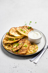 Zucchini fritters with sour cream sauce. Space for text.