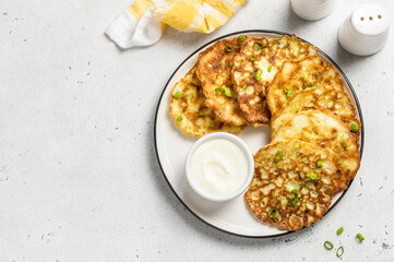 Spicy vegan vegetable pancakes with yogurt sauce. Space for text.