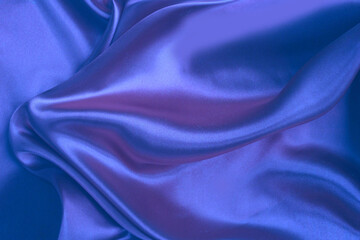 Blue satin background. Silk fabric with pleats. Satin, silk or satin create a beautiful drapery. Fashionable design.