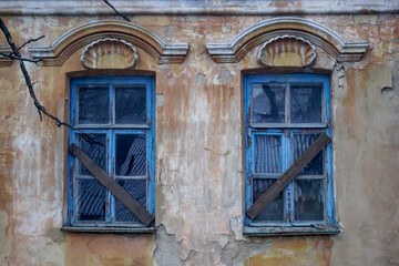 Fototapeta na wymiar Windows of an old abandoned house