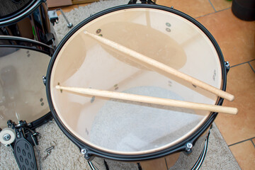 Drum-sticks lying on a drum