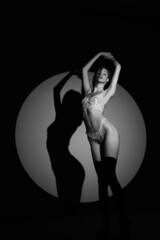 Beautiful girl posing in a photo studio. Shooting with gobo masks