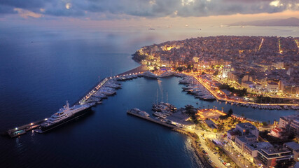 Naklejka premium Aerial drone photo of iconic round port and Marina of Zea or Passalimani at dusk with beautiful colours, Piraeus, Attica, Greece