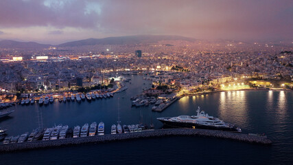 Fototapeta na wymiar Aerial drone photo of iconic round port and Marina of Zea or Passalimani at dusk with beautiful colours, Piraeus, Attica, Greece