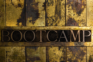 Bootcamp text message on textured grunge copper and vintage gold background