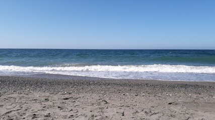 Heavy waves are ending their run on the shore.