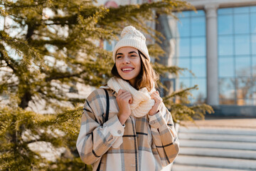 young smiling woman walking in street in winter