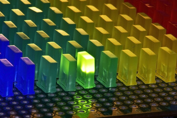 Even rows of rectangular LEDs with a glowing green LED on a circuit board