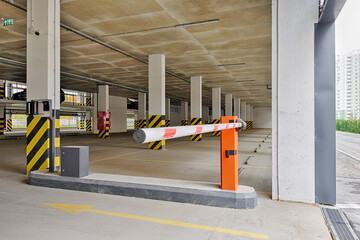 Automatic barrier gate at the entrance to a typical multi-storey car park. Closed barrier of car parking