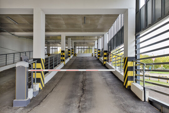 Automatic barrier gate at the entrance to a typical multi-storey car park. Closed barrier of car parking