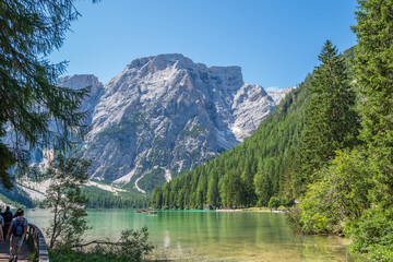 Plakat Lake Braies (also known as Pragser Wildsee or Lago di Braies) in Dolomites Mountains, Sudtirol, Italy. Romantic place with typical wooden boats on the alpine lake. Hiking travel and adventure.