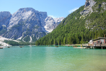 Lake Braies (also known as Pragser Wildsee or Lago di Braies) in Dolomites Mountains, Sudtirol, Italy. Romantic place with typical wooden boats on the alpine lake. Hiking travel and adventure.