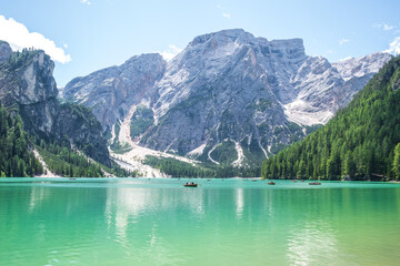 Fototapeta na wymiar Lake Braies (also known as Pragser Wildsee or Lago di Braies) in Dolomites Mountains, Sudtirol, Italy. Romantic place with typical wooden boats on the alpine lake. Hiking travel and adventure.