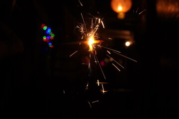 A burning sparkler on the black