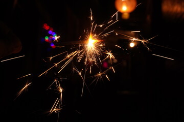 A burning sparkler on the black
