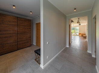 Modern interior of luxury private house. Entrance hall. Living room.