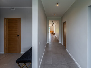 Modern interior of luxury private house. Entrance hall. Living room.
