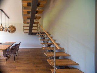 Modern interior of luxury private house. Wooden stairs.