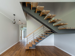 Modern interior of empty apartment. Wooden stairs.