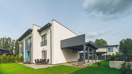 Fototapeta na wymiar Modern exterior of luxury private house. Garden with green lawn.