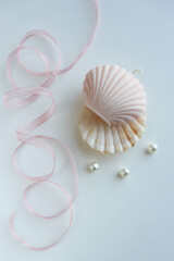 interior candle handmade from natural wax in the form of a shell on a white background