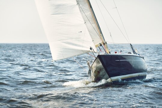 Heeled sloop rigged yacht sailing in an open Baltic sea on a clear day. Regatta, racing, sport, recreation, leisure activity, transportation, nautical vessel, adventure