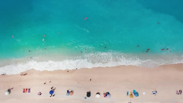 Aerial view of people sunbathing at the exotic turquoise sea of Myrtos beach at Kefalonia island, Greece