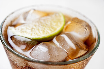 Alcoholic cocktail of rum with ice and lime, close-up, macro photography.