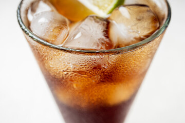 Alcoholic cocktail of rum with ice and lime, close-up, macro photography.