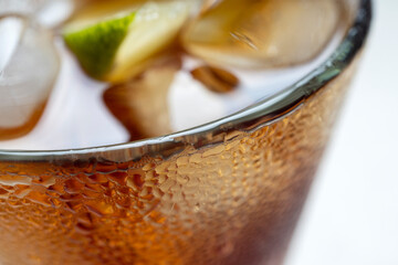 Alcoholic cocktail of rum with ice and lime, close-up, macro photography.