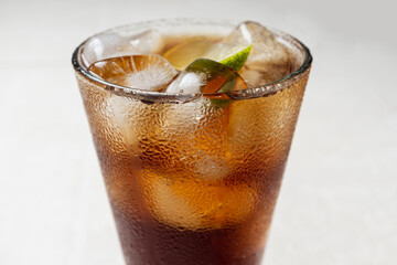 Alcoholic cocktail of rum with ice and lime, close-up, macro photography.