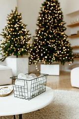 Stylish living room interior with little fir trees and Christmas decorations