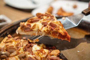 a slice of pizza being lifted