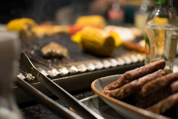 close up of a grill and tongs for vegetables and meat