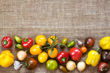 Assortment of colorful fresh vegetables on sackcloth background