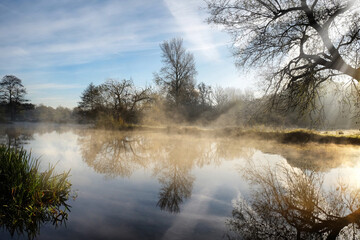 Naklejka na ściany i meble Sun flare and mist on the River Wey, Godalming, Surrey, UK