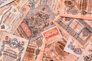 Chaotically scattered old worn ruble banknotes of royal russia. Top view