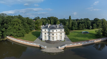 Castle in the Belgian countryside Hof ter Linde in Edegem near Antwerp by a lake or pond. Drone aerial view