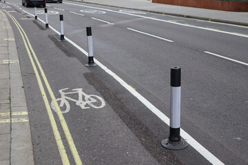 segregated cycle lane with bollards and double yellow road markings in West London