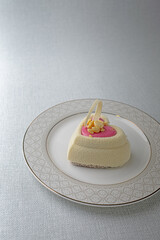 heart-shaped cake with pink icing and nuts